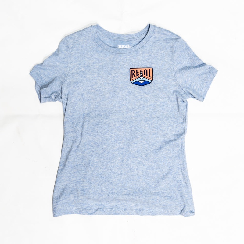 REAL Wmn’s Lighthouse Badge Tee-Heather Prism Blue